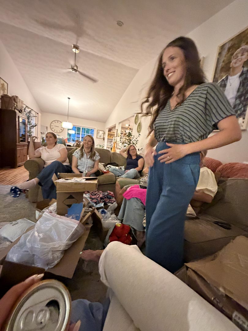 Guest showing off a mystery outfit find with friends looking on