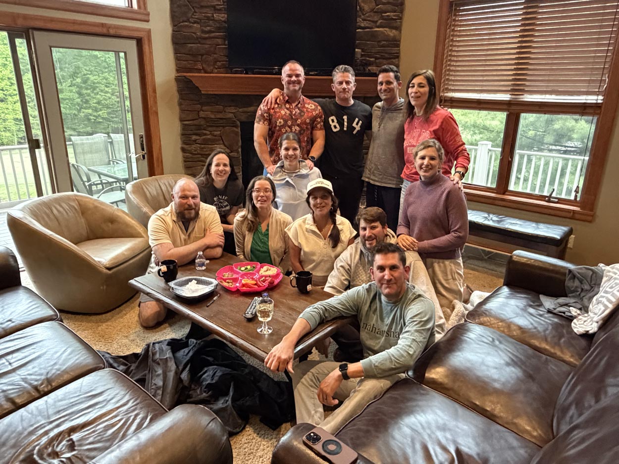 Group of friends gathered around a coffee table at a mystery party